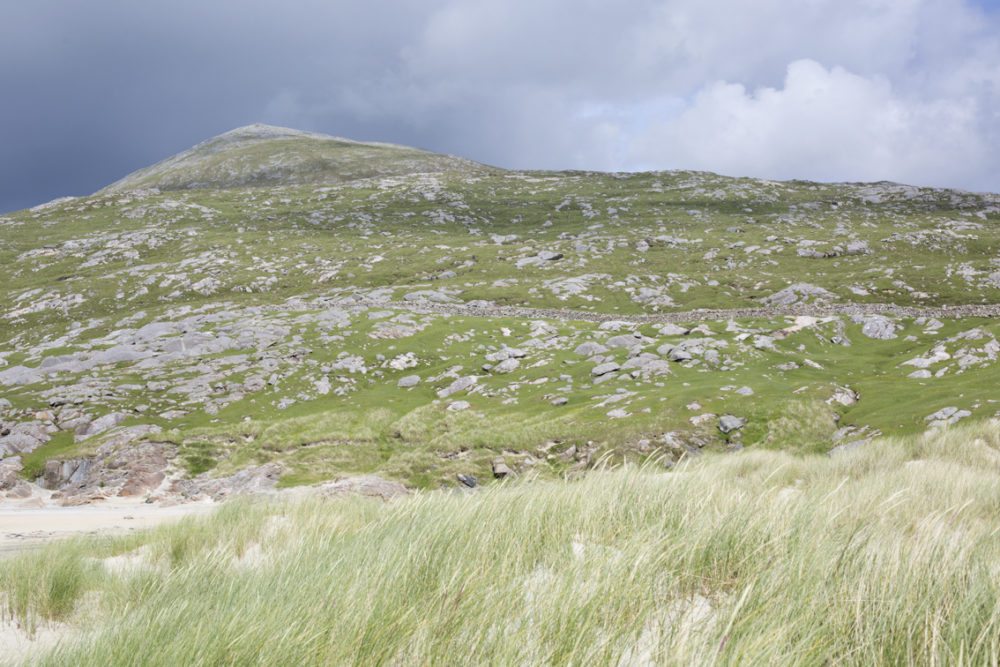 Stony Hebridean hill with machair grass in front