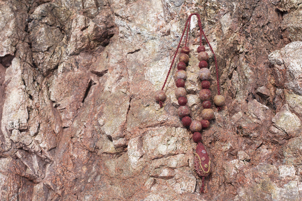 Felted bronze teardrop amulet designed by Alice Starmore