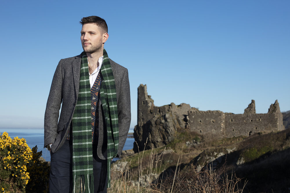 Musician Colm Keegan wearing the Rosemarkie waistcoat and a woven scarf by Alice Starmore