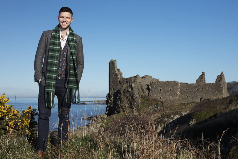 Musician Colm Keegan wearing the Rosemarkie waistcoat and a woven scarf by Alice Starmore