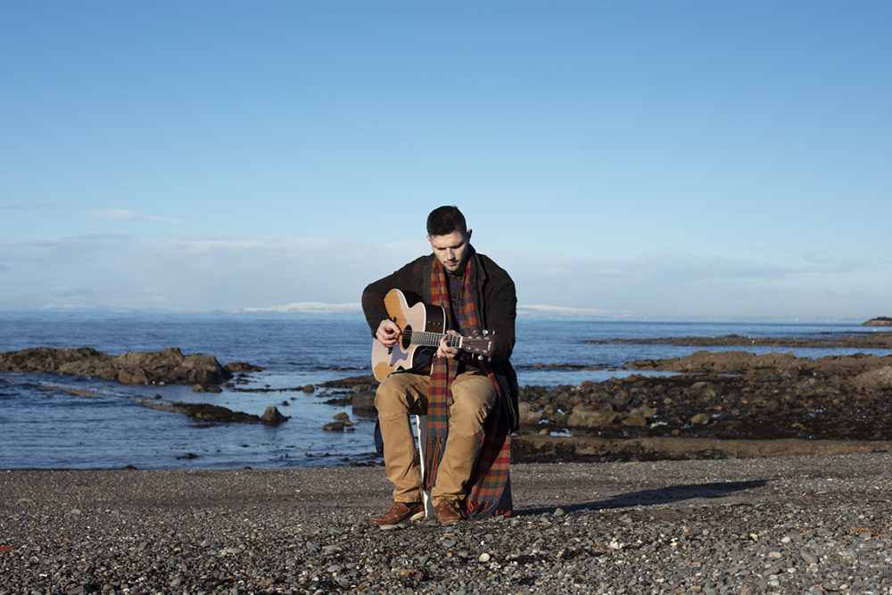 Musician Colm Keegan wearing a woven scarf by Alice Starmore