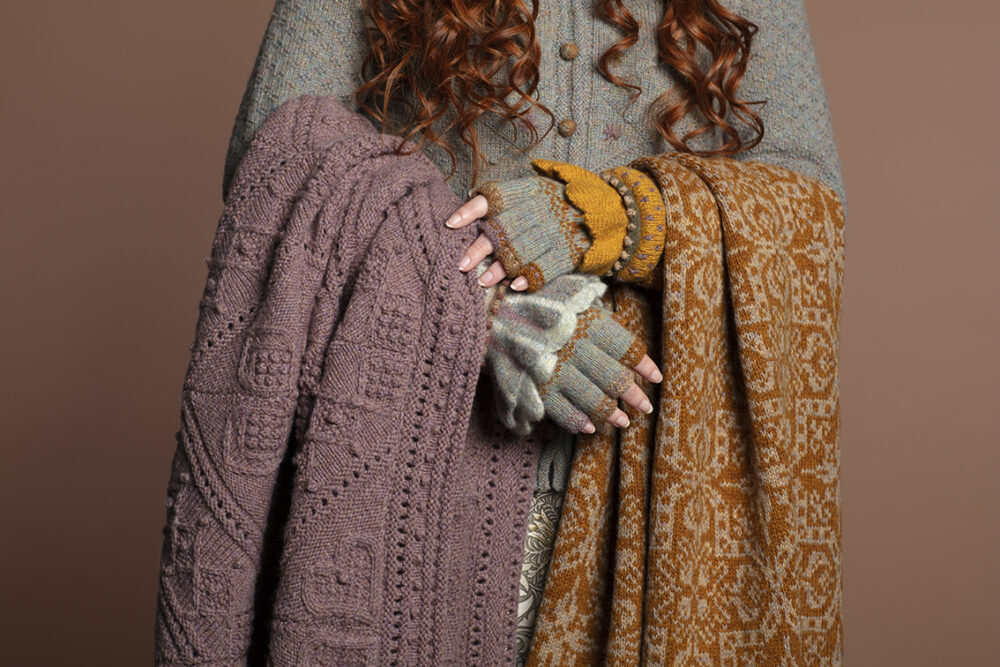 The Mountain Hare Jacket from the book Glamourie, the Mo Chridhe Blanket from the Infinite Cable Class, Dun Cuffs from Creative Course 2 and gloves from the Hirta Hat Set patterncard kits, all designs by Alice Starmore, also the Persian Tiles from the book A Collector's Item by Jade Starmore