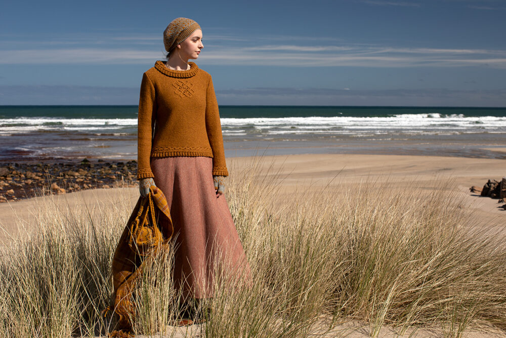 The Eightsome Reel hand knitwear patterncard kit design by Alice Starmore in Hebridean 3 Ply, worn with the Hirta Hat Set patterncard kit in Hebridean 2 ply, the Sporran Bag from Creative Course 3 and the Breacan Wrap from Woven Design Plans.