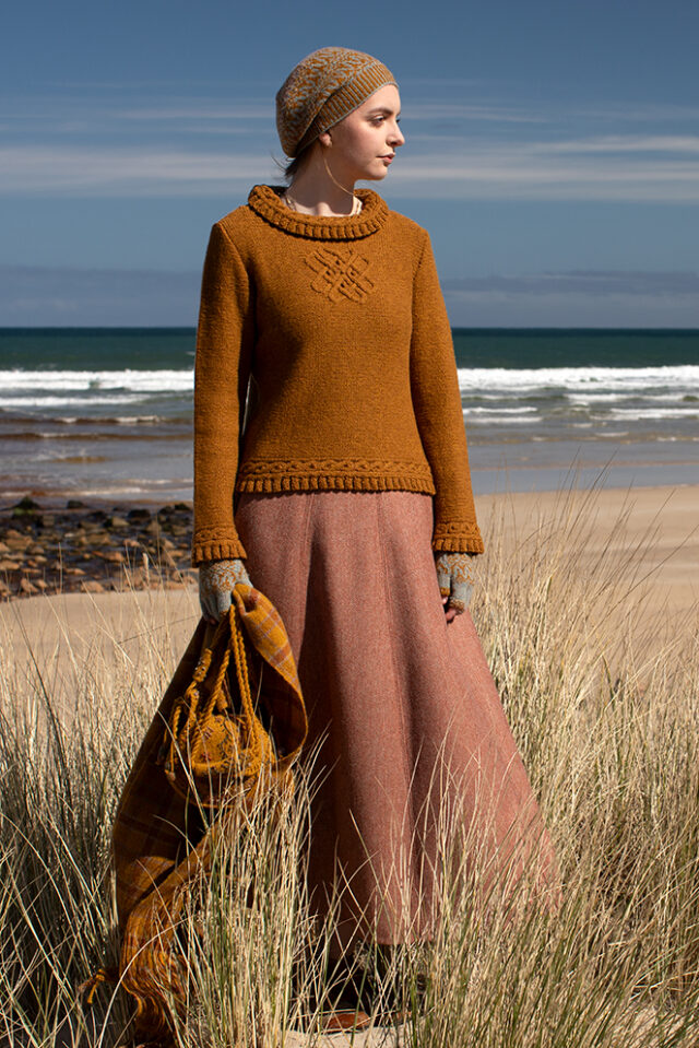 The Eightsome Reel hand knitwear patterncard kit design by Alice Starmore in Hebridean 3 Ply, worn with the Hirta Hat Set patterncard kit in Hebridean 2 ply, the Sporran Bag from Creative Course 3 and the Breacan Wrap from Woven Design Plans.