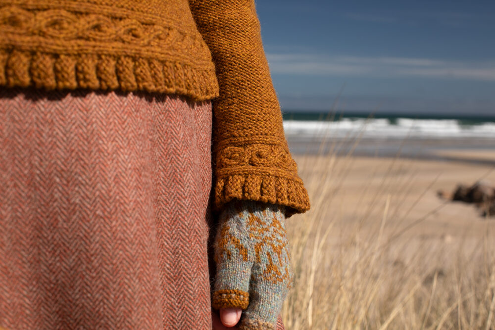 The Eightsome Reel hand knitwear patterncard kit design by Alice Starmore in Hebridean 3 Ply, worn with the Hirta Hat Set patterncard kit in Hebridean 2 ply.
