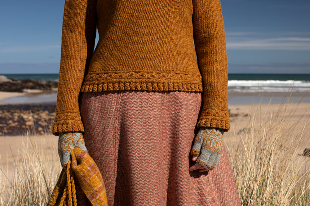 The Eightsome Reel hand knitwear patterncard kit design by Alice Starmore in Hebridean 3 Ply, worn with the Hirta Hat Set patterncard kit in Hebridean 2 ply.