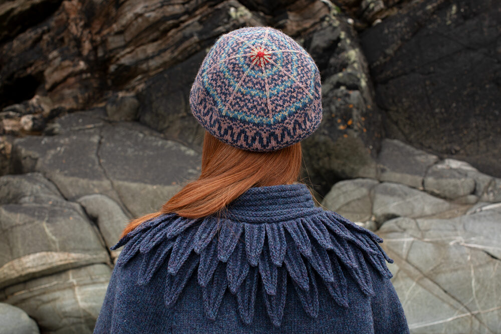 The Raven Poncho and Hirta Hat Set patterncard kit designs by Alice Starmore in Hebridean 2 & 3 Ply and a cuff from Creative Course 2